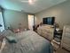This bedroom has a TV, drawers and a large bed at 1166 Heron Sound Dr, Apopka, FL 32703