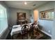 Elegant dining room featuring a set table, decorative art, and inviting ambiance at 1166 Heron Sound Dr, Apopka, FL 32703