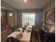 Charming dining room with a set table, art, and a window offering natural light at 1166 Heron Sound Dr, Apopka, FL 32703