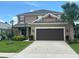 Charming two-story home with well-manicured lawn, two-car garage, and beautiful landscaping at 1166 Heron Sound Dr, Apopka, FL 32703