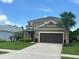Charming two-story home with well-manicured lawn, two-car garage, and beautiful landscaping at 1166 Heron Sound Dr, Apopka, FL 32703
