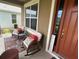 Inviting front porch with rocking chairs, creating a cozy outdoor seating area at 1166 Heron Sound Dr, Apopka, FL 32703