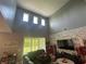 A comfortable living room features high ceilings and clerestory windows at 1166 Heron Sound Dr, Apopka, FL 32703