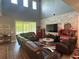 This living room features high ceilings, clerestory windows, and a stacked stone accent wall at 1166 Heron Sound Dr, Apopka, FL 32703