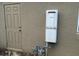 Tankless water heater mounted on the exterior of the house near a back door at 1166 Heron Sound Dr, Apopka, FL 32703