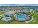 A resort-style pool area with ample seating, a splash pad, and palm trees for a relaxing experience at 13829 Destin Beach Ln, Orlando, FL 32827