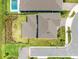 Aerial view highlights roof, backyard, and fence with a basketball hoop, set in a neighborhood at 13829 Destin Beach Ln, Orlando, FL 32827