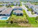 Aerial shot of a house with a backyard, pool, and nearby pond in a residential neighborhood at 13829 Destin Beach Ln, Orlando, FL 32827