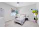 Cozy bedroom with carpet and natural light showcases a comfy bed and simple decorations at 13829 Destin Beach Ln, Orlando, FL 32827