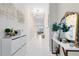 Stylish hallway with decorative mirror, light-colored walls, and tiled flooring at 13829 Destin Beach Ln, Orlando, FL 32827