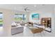 Comfortable living room featuring a modern sofa, a ceiling fan, and a view of the outdoor landscape at 13829 Destin Beach Ln, Orlando, FL 32827