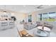 Open-concept living space with modern decor, featuring kitchen with seating and living room at 13829 Destin Beach Ln, Orlando, FL 32827