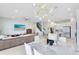 Open-concept living area featuring modern lighting, marble dining table, stairs, and an open view to the kitchen at 13829 Destin Beach Ln, Orlando, FL 32827
