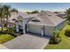 Stunning aerial view of a home featuring a spacious three-car garage and a beautifully paved driveway at 15521 Sandfield Loop, Winter Garden, FL 34787