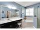 A bathroom featuring a soaking tub, a glass-enclosed shower, and a large vanity area at 15521 Sandfield Loop, Winter Garden, FL 34787
