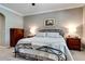 Bright bedroom featuring soft colors, neutral walls, a queen bed, and classic decor at 15521 Sandfield Loop, Winter Garden, FL 34787