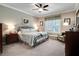 Tranquil bedroom featuring soft colors, neutral walls, a queen bed, and classic decor at 15521 Sandfield Loop, Winter Garden, FL 34787
