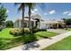 Beautiful single-story home with a well-manicured lawn, lush landscaping, and a three-car garage at 15521 Sandfield Loop, Winter Garden, FL 34787