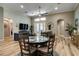 Open living and dining area with a ceiling fan, lots of natural light, and wood-style floors at 15521 Sandfield Loop, Winter Garden, FL 34787