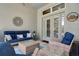 Covered patio featuring cozy seating, rattan furniture, and view to backyard at 15521 Sandfield Loop, Winter Garden, FL 34787