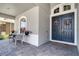 Inviting front porch with double doors adorned with wreaths, seating, and a 'Welcome' mat at 15521 Sandfield Loop, Winter Garden, FL 34787