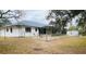 Fenced backyard featuring a screened-in lanai, a storage shed, and ample space for outdoor enjoyment at 15683 Sw 46Th Cir, Ocala, FL 34473