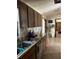 Functional kitchen with wood cabinets, a sink, and a view into the adjoining room at 15683 Sw 46Th Cir, Ocala, FL 34473