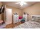 Bedroom features a ceiling fan and cozy bed with a floral quilt, creating a warm and inviting atmosphere at 1603 15Th, Sanford, FL 32771