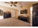 Bedroom with hardwood floors, ceiling fan, TV, black dressers and access to an ensuite bathroom at 1603 15Th, Sanford, FL 32771