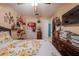 Charming bedroom with a floral bedspread, wood-look flooring, and ample storage, creating a comfortable and functional space at 1603 15Th, Sanford, FL 32771