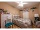 Comfortable bedroom with tile floors, a ceiling fan, and a quilt-covered bed, creating a cozy and inviting atmosphere at 1603 15Th, Sanford, FL 32771