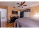 Comfortable bedroom with a ceiling fan, a gray quilt-covered bed, and wood-look flooring, creating a cozy and inviting space at 1603 15Th, Sanford, FL 32771