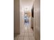 Long hallway with white tile floors, light fixture, and access to other rooms in the house at 1603 15Th, Sanford, FL 32771