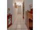 Bright hallway featuring tile flooring, neutral walls, and decorative lighting at 1603 15Th, Sanford, FL 32771