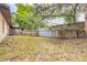 Fenced backyard with grass, wooden fencing, and a concrete block wall at 1710 Espanola Ave, Daytona Beach, FL 32117