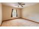 Bedroom featuring a ceiling fan, tile flooring, and a window with curtains at 1710 Espanola Ave, Daytona Beach, FL 32117