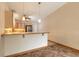 Kitchen features wood cabinets, stainless steel appliances, and breakfast bar with pendant lighting at 1710 Espanola Ave, Daytona Beach, FL 32117
