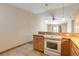 Well-lit kitchen featuring sleek appliances and wooden cabinetry at 1710 Espanola Ave, Daytona Beach, FL 32117