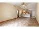 Inviting living room boasts tile floors, vaulted ceilings with fan, and bar-style seating area at 1710 Espanola Ave, Daytona Beach, FL 32117