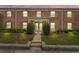 Charming brick building with well-maintained landscaping, green shutters and inviting entryway at 202 Georgetown Dr # C, Casselberry, FL 32707