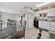 Bright, tiled kitchen adjacent to a living area featuring white appliances at 202 Georgetown Dr # C, Casselberry, FL 32707