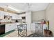Eat-in kitchen with white cabinets, appliances, and in unit washer and dryer at 202 Georgetown Dr # C, Casselberry, FL 32707