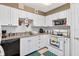 Kitchen with white cabinets and appliances, plus a window for natural light at 202 Georgetown Dr # C, Casselberry, FL 32707