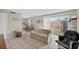 Bright living room with neutral colors, tile flooring, and sliding glass door to a patio at 202 Georgetown Dr # C, Casselberry, FL 32707