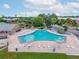 Community pool surrounded by lounge chairs and lush landscaping at 202 Georgetown Dr # C, Casselberry, FL 32707