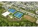 Aerial view showcasing the community sports courts with basketball, tennis, and sand volleyball at 2043 Rock Maple Bnd, Kissimmee, FL 34746
