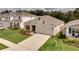 Beautiful aerial view of a cozy home, colorful landscaping, and green lawn at 2043 Rock Maple Bnd, Kissimmee, FL 34746