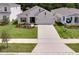 Beautiful home with manicured lawn, flowerbeds, and a long driveway at 2043 Rock Maple Bnd, Kissimmee, FL 34746