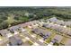 Aerial view of the home in a residential neighborhood with lush trees and pond, outlined in red at 2043 Rock Maple Bnd, Kissimmee, FL 34746
