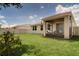A well-maintained backyard featuring lush green grass and a screened lanai for outdoor relaxation at 2043 Rock Maple Bnd, Kissimmee, FL 34746